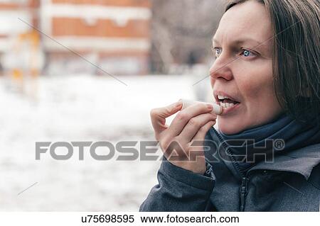 Woman applying lip balm View Large Photo Image Stock Photography - Woman applying lip balm. Fotosearch
