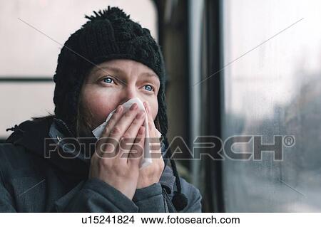 Picture - Woman blowing her nose. Fotosearch