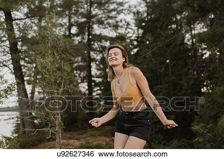 Stock Photograph - Woman dancing with eyes closed in forest. Fotosearch