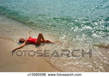 Stock Photo - Woman enjoying beach. Fotosearch
