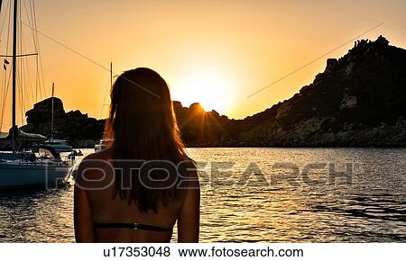 Woman enjoying sunset at sea, La Maddalena island, Sardegna, Italy View Large Photo Image Stock Photo - Woman enjoying sunset at sea, La Maddalena island, Sardegna, Italy. Fotosearch