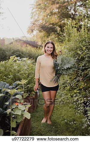 Woman gardener with fresh produce from garden View Large Photo Image Stock Photo - Woman gardener with fresh produce from garden. Fotosearch