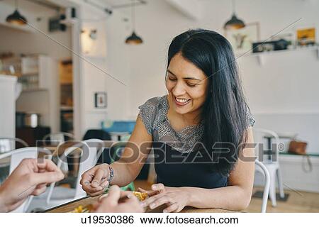 Stock Photograph - Woman having meal in restaurant. Fotosearch