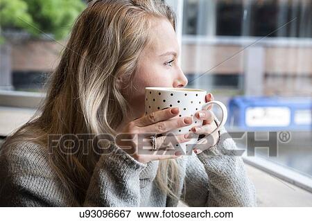 Woman having tea in cafe View Large Photo Image Stock Photo - Woman having tea in cafe. Fotosearch