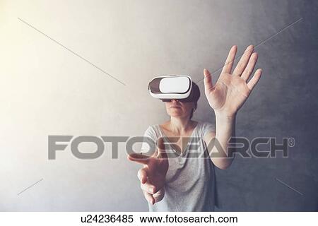Woman immersed in virtual reality View Large Photo Image Stock Photography - Woman immersed in virtual reality. Fotosearch