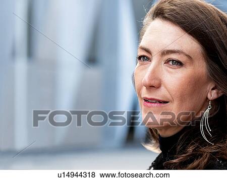 Stock Photo - Woman in black suit walking in city. Fotosearch
