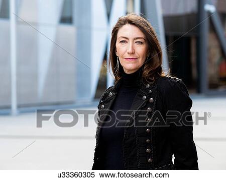 Woman in black suit walking in city View Large Photo Image Stock Photography - Woman in black suit walking in city. Fotosearch