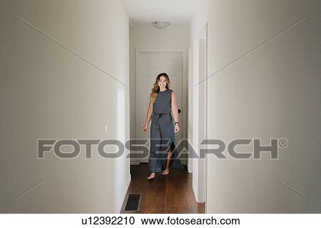 Woman in hallway of home View Large Photo Image Stock Image - Woman in hallway of home. Fotosearch