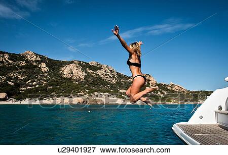 Woman jumping into sea from yacht, La Maddalena island, Sardegna, Italy View Large Photo Image Stock Photo - Woman jumping into sea from yacht, La Maddalena island, Sardegna, Italy. Fotosearch