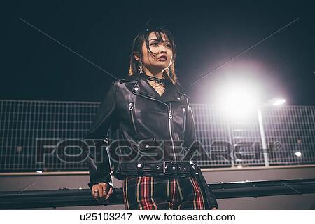 Woman leaning against railing, fencing and floodlights in background, Milan, Italy View Large Photo Image Stock Photo - Woman leaning against railing, fencing and floodlights in background, Milan, Italy. Fotosearch