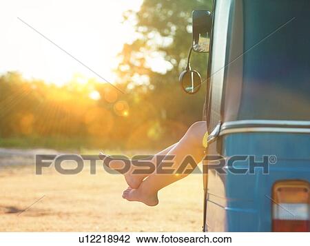 Woman legs sticking out of van on hot day View Large Photo Image Stock Image - Woman legs sticking out of van on hot day. Fotosearch