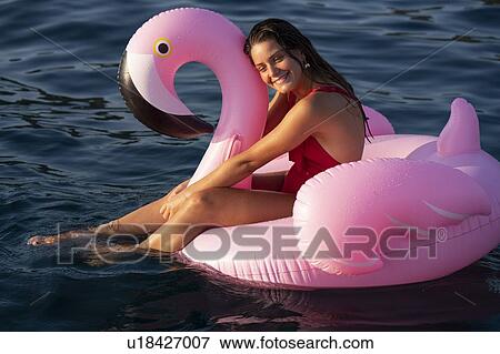 Woman on flamingo float on sea, Italy View Large Photo Image Stock Photo - Woman on flamingo float on sea, Italy. Fotosearch