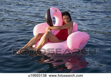 Woman on flamingo float on sea, Italy View Large Photo Image Stock Photo - Woman on flamingo float on sea, Italy. Fotosearch