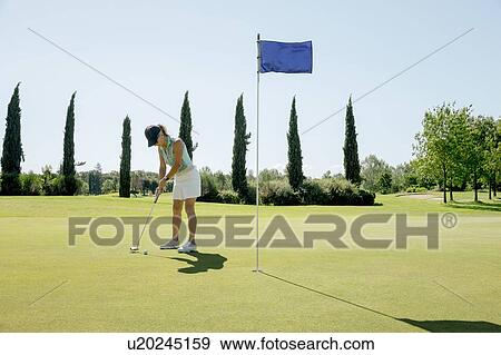 Woman playing golf on golf course View Large Photo Image Stock Photo - Woman playing golf on golf course. Fotosearch