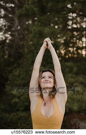 Woman practising yoga in forest View Large Photo Image Stock Image - Woman practising yoga in forest. Fotosearch