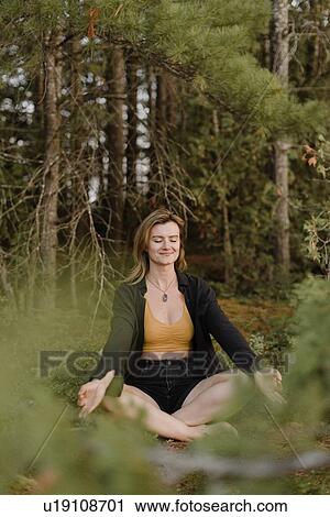 Woman practising yoga in forest View Large Photo Image Stock Image - Woman practising yoga in forest. Fotosearch