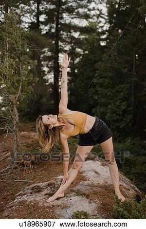 Woman practising yoga in forest View Large Photo Image Stock Photo - Woman practising yoga in forest. Fotosearch