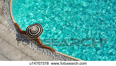 Stock Photo - Woman relaxing in swimming pool. Fotosearch