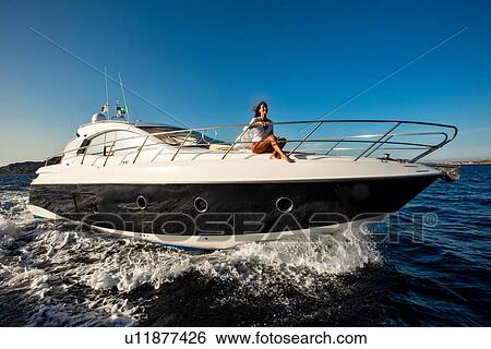 Stock Photograph - Woman relaxing on yacht. Fotosearch