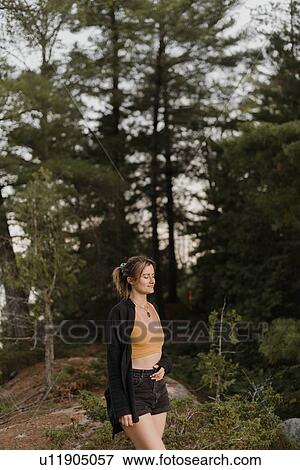 Stock Photo - Woman relaxing with eyes closed in forest. Fotosearch