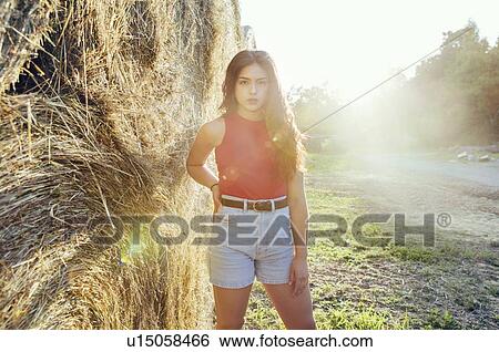 Woman standing by round bales of hay, Wilhelminenberg, Vienna, Austria View Large Photo Image Stock Photograph - Woman standing by round bales of hay, Wilhelminenberg, Vienna, Austria. Fotosearch
