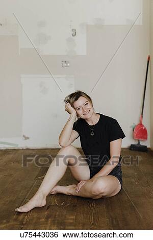 Woman taking break from painting new home View Large Photo Image Stock Photograph - Woman taking break from painting new home. Fotosearch
