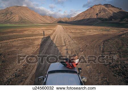 Woman traveller enjoying scenic view on vehicle, Landmannalaugar, Highlands, Iceland View Large Photo Image Stock Image - Woman traveller enjoying scenic view on vehicle, Landmannalaugar, Highlands, Iceland. Fotosearch