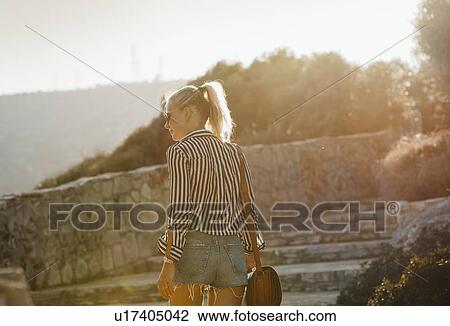 Stock Image - Woman traveller exploring island, Garraf, Spain. Fotosearch
