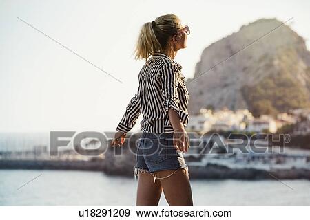 Stock Photo - Woman traveller exploring island, Garraf, Spain. Fotosearch