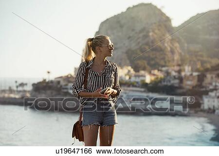 Stock Photograph - Woman traveller exploring island, Garraf, Spain. Fotosearch