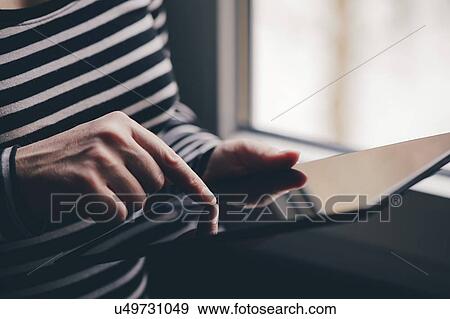 Stock Photo - Woman using tablet computer. Fotosearch