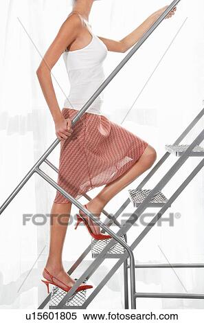 Stock Photography - Woman wearing stilleto heel on metal staircase. Fotosearch