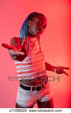Woman with arm reaching out against red background View Large Photo Image Stock Image - Woman with arm reaching out against red background. Fotosearch