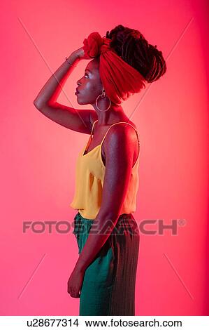 Woman with headscarf posing against pink background View Large Photo Image Picture - Woman with headscarf posing against pink background. Fotosearch