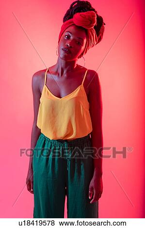 Woman with headscarf posing against pink background View Large Photo Image Stock Photo - Woman with headscarf posing against pink background. Fotosearch