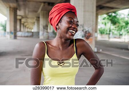 Stock Photo - Woman with red turban in city. Fotosearch