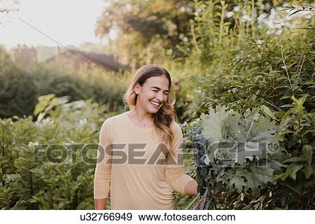 Woman working in her garden View Large Photo Image Stock Photo - Woman working in her garden. Fotosearch