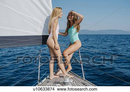 Picture - Women talking on bow of sailboat, Italy. Fotosearch
