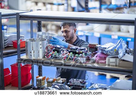 Worker picking products from stores in electronics assembly factory View Large Photo Image Stock Image - Worker picking products from stores in electronics assembly factory. Fotosearch