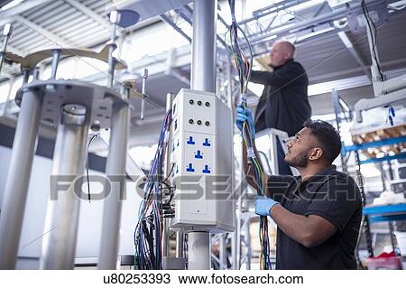 Workers assembling operating theatre lighting in electronics assembly factory View Large Photo Image Stock Image - Workers assembling operating theatre lighting in electronics assembly factory. Fotosearch