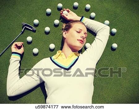 Young Beautiful Woman Lying on fairway with Golf Balls View Large Photo Image Stock Photo - Young Beautiful Woman Lying on fairway with Golf Balls. Fotosearch