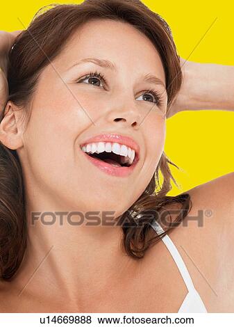 Young Brunette Woman Laughing against yellow background View Large Photo Image Stock Photo - Young Brunette Woman Laughing against yellow background. Fotosearch