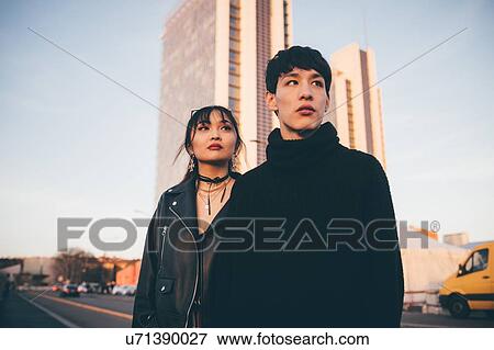 Young couple, high-rise building in background, Milan, Italy View Large Photo Image Stock Photo - Young couple, high-rise building in background, Milan, Italy. Fotosearch