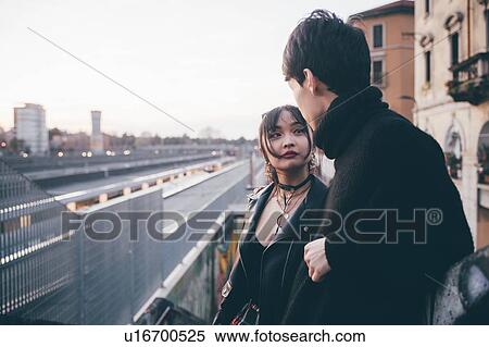 Stock Photography - Young couple in train station, Milan, Italy. Fotosearch