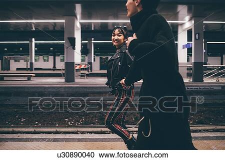 Young couple running on platform in train station, Milan, Italy View Large Photo Image Stock Image - Young couple running on platform in train station, Milan, Italy. Fotosearch