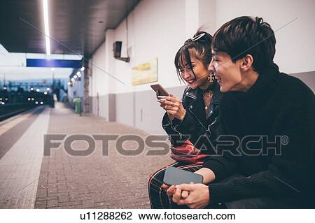 Young couple sharing text on train platform, Milan, Italy View Large Photo Image Stock Image - Young couple sharing text on train platform, Milan, Italy. Fotosearch