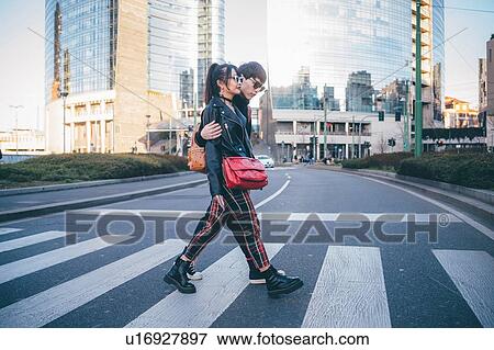 Young couple using pedestrian crossing, Milan, Italy View Large Photo Image Stock Photo - Young couple using pedestrian crossing, Milan, Italy. Fotosearch