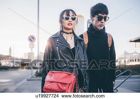 Picture - Young couple walking on street, Milan, Italy. Fotosearch
