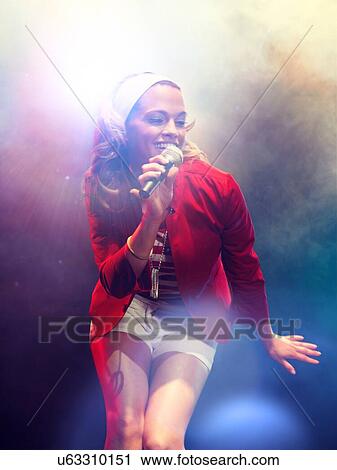 Young female rockstar Singing in Concert View Large Photo Image Stock Image - Young female rockstar Singing in Concert. Fotosearch