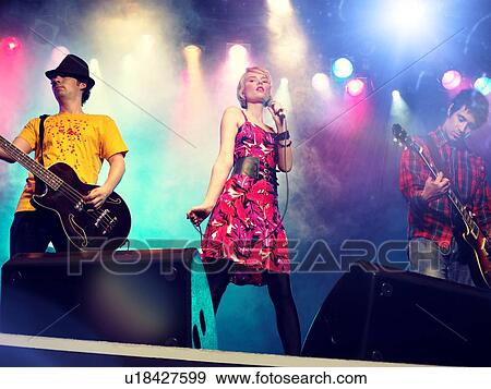 Stock Photo - Young female rockstar Singing in Concert. Fotosearch